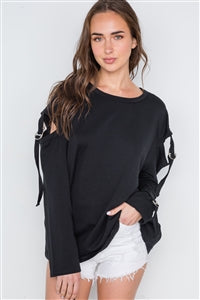 Image of a black sweater with strappy sleeve cutouts and a round neckline.